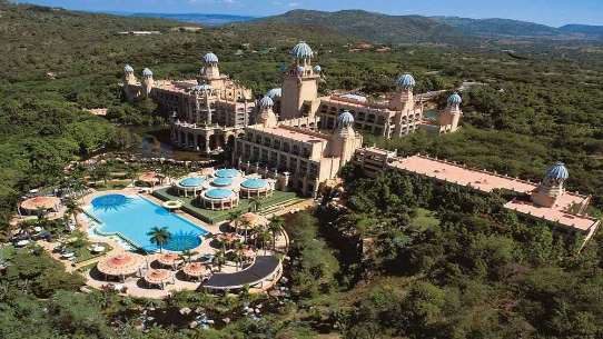 The Palace of the Lost City from the air, its domes and pools set in wooded hills